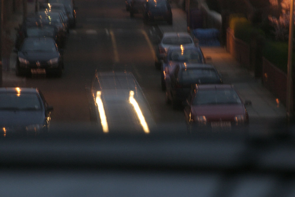 Cars travelling at night down a street in Liverpool - taken on a 2 second exposure.