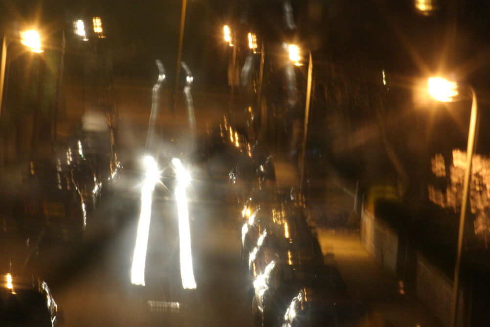 Cars travelling at night down a street in Liverpool - taken on a 2 second exposure.