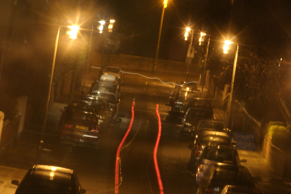 Cars travelling at night down a street in Liverpool - taken on a 2 second exposure.