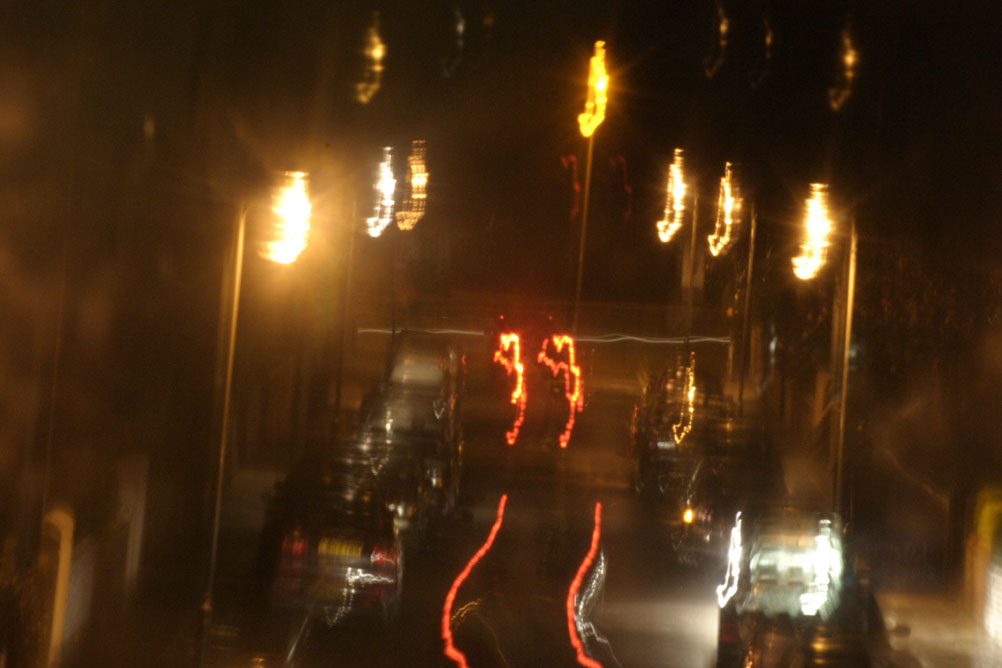 Cars travelling at night down a street in Liverpool - taken on a 2 second exposure.