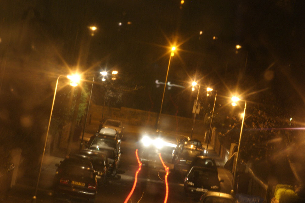 Cars travelling at night down a street in Liverpool - taken on a 2 second exposure.